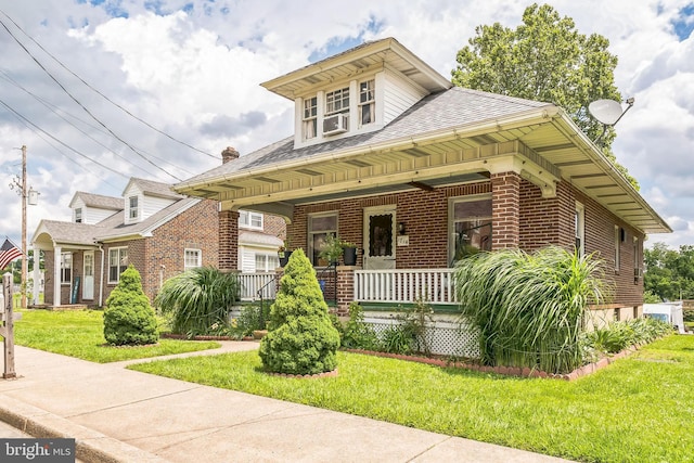 1714 S Main St, Bechtelsville, PA 19505 - view of front of house with a porch, brick siding, a front yard, and a shingled roof
