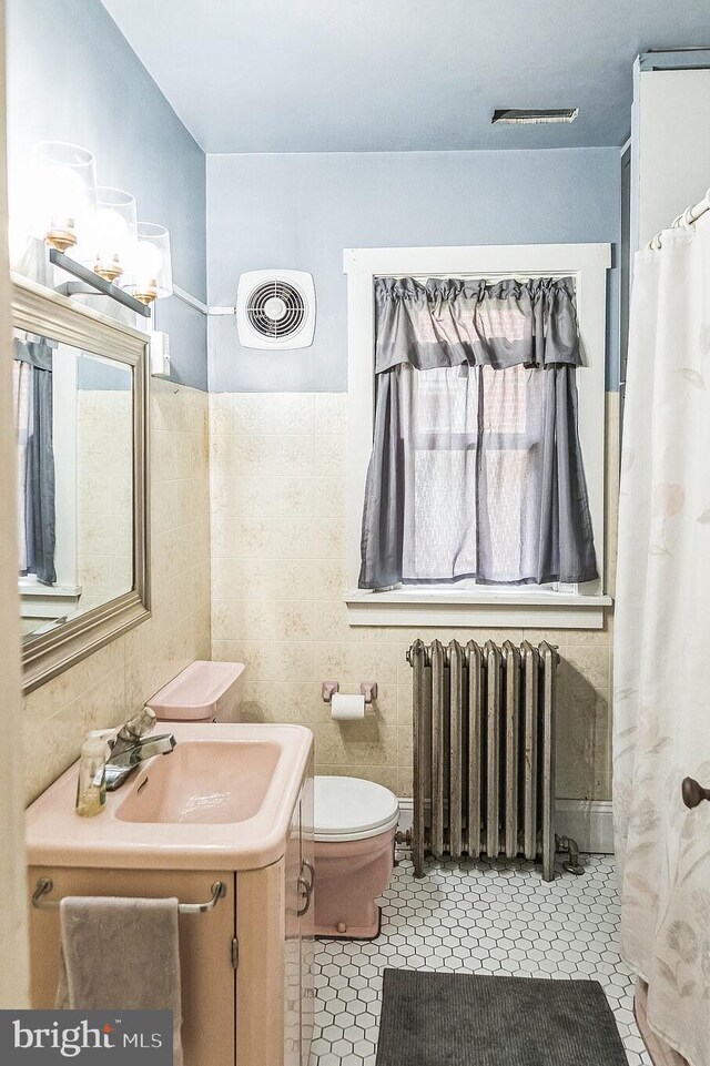 1714 S Main St, Bechtelsville, PA 19505 - bathroom featuring radiator heating unit, vanity, tile patterned floors, and curtained shower