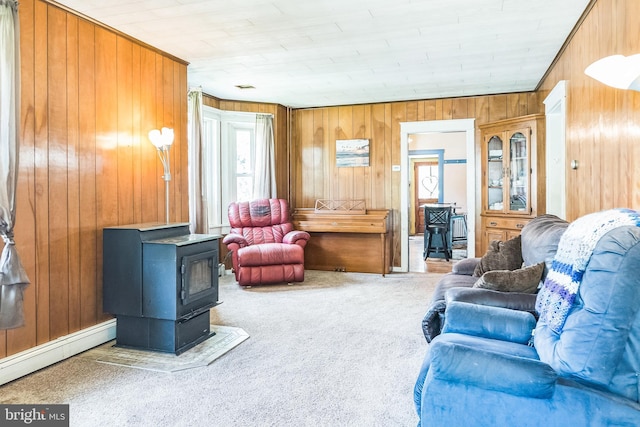 1714 S Main St, Bechtelsville, PA 19505 - living room featuring a wood stove, wood walls, carpet flooring, and baseboard heating