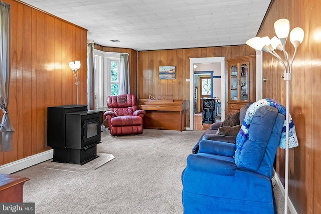 1714 S Main St, Bechtelsville, PA 19505 - living room with a wood stove, carpet, and wood walls