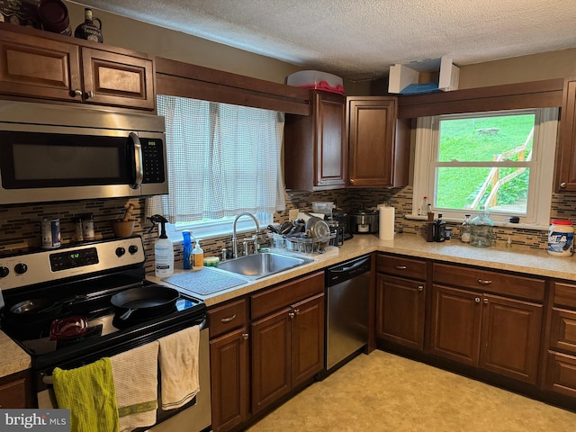 42 Reed St, Mohnton, PA 19540 - kitchen with appliances with stainless steel finishes, light countertops, tasteful backsplash, and a textured ceiling