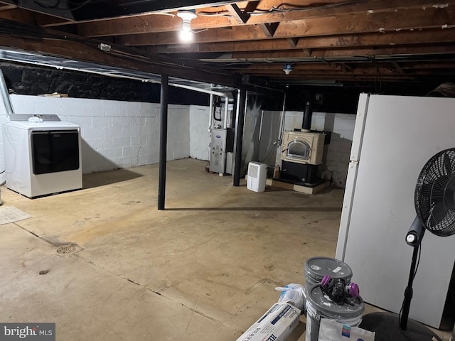 42 Reed St, Mohnton, PA 19540 - unfinished basement featuring washer / dryer, freestanding refrigerator, and heating unit