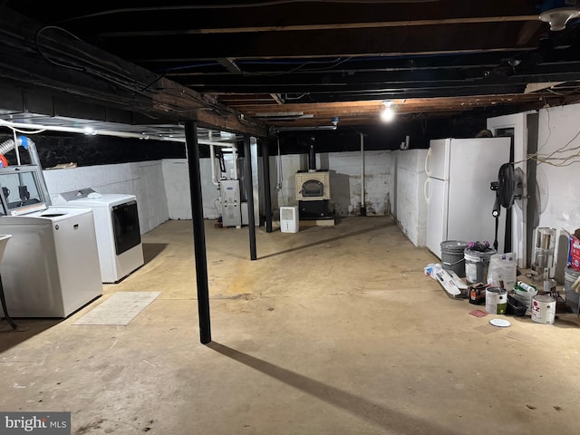 42 Reed St, Mohnton, PA 19540 - unfinished below grade area with separate washer and dryer, freestanding refrigerator, and heating unit