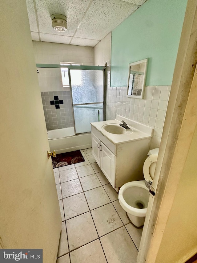 1618 S 6th St, Philadelphia, PA 19148 - full bathroom featuring tile patterned floors, vanity, bath / shower combo with glass door, a paneled ceiling, and tile walls