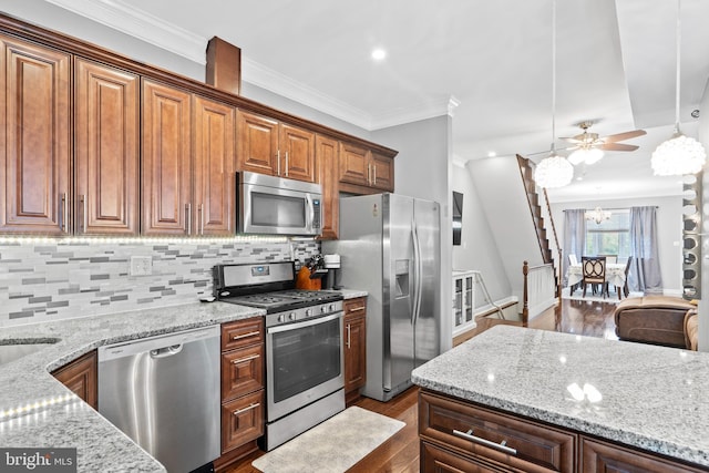 3207 Salmon St, Philadelphia, PA 19134 - kitchen with appliances with stainless steel finishes, dark wood-type flooring, ornamental molding, and light stone counters