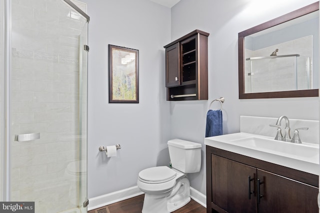 3207 Salmon St, Philadelphia, PA 19134 - bathroom featuring vanity, a shower stall, and wood finished floors