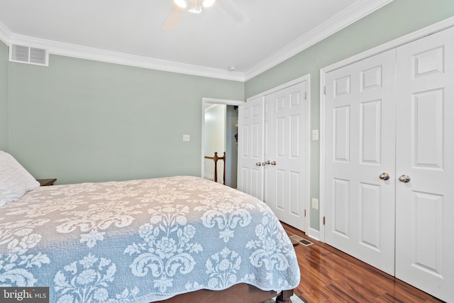 3207 Salmon St, Philadelphia, PA 19134 - bedroom featuring multiple closets, crown molding, dark wood-style flooring, and a ceiling fan