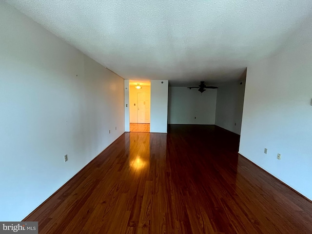 15100 Interlachen Dr Unit 4-701, Silver Spring, MD 20906 - empty room with wood finished floors, ceiling fan, and a textured ceiling