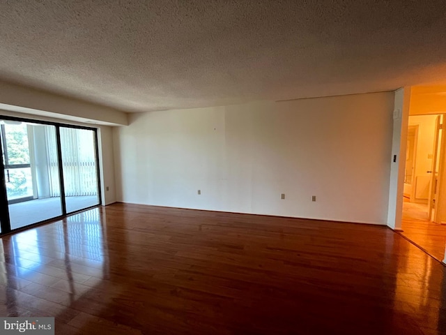 15100 Interlachen Dr Unit 4-701, Silver Spring, MD 20906 - spare room featuring wood finished floors and a textured ceiling