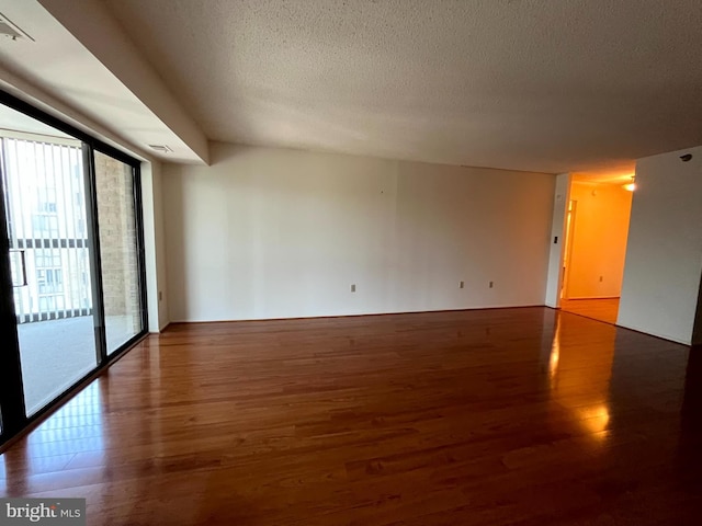 15100 Interlachen Dr Unit 4-701, Silver Spring, MD 20906 - unfurnished room featuring wood finished floors and a textured ceiling