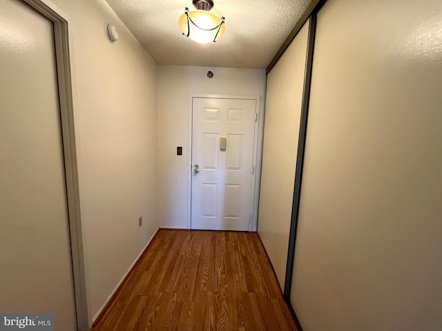 15100 Interlachen Dr Unit 4-701, Silver Spring, MD 20906 - hall featuring wood finished floors and a textured ceiling