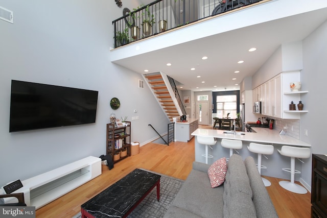 1318 E Eyre St, Philadelphia, PA 19125 - living area with light wood-style flooring, stairs, and recessed lighting