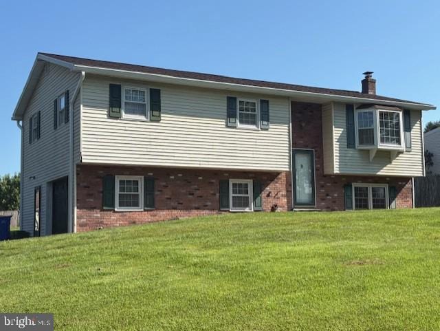225 Bobby Jones Dr, Etters, PA 17319 - bi-level home featuring brick siding, a front yard, a chimney, and a garage