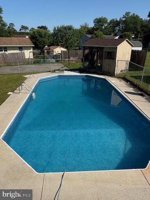225 Bobby Jones Dr, Etters, PA 17319 - view of pool featuring a fenced backyard and a storage unit
