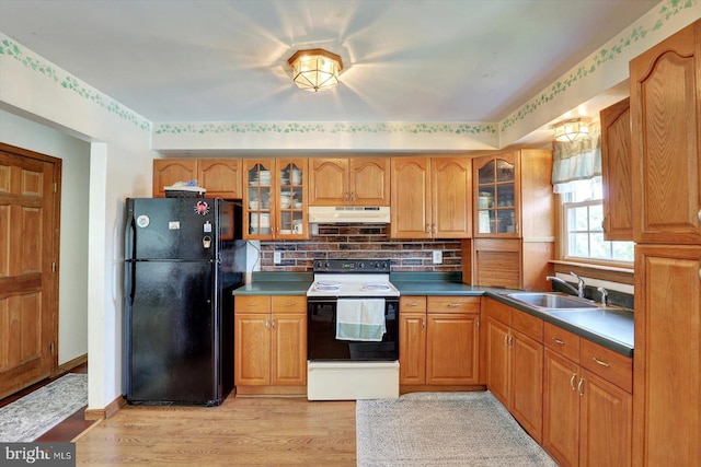 225 Bobby Jones Dr, Etters, PA 17319 - kitchen featuring white electric range oven, freestanding refrigerator, under cabinet range hood, and glass insert cabinets