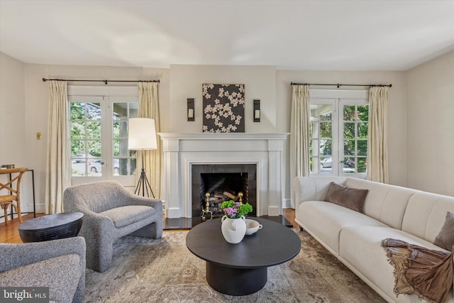 508 Baird Rd, Merion Station, PA 19066 - living room with healthy amount of natural light, wood finished floors, and a fireplace with flush hearth