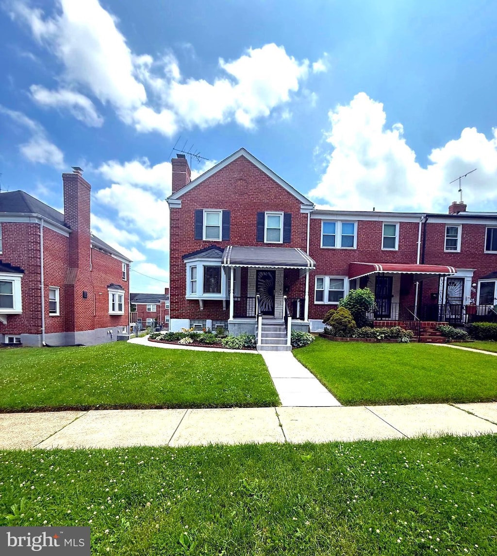 1513 Northbourne Rd, Baltimore, MD 21239 - view of property featuring a front yard and brick siding