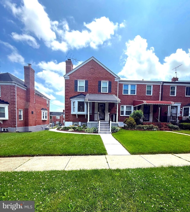 1513 Northbourne Rd, Baltimore, MD 21239 - view of property featuring a front yard and brick siding