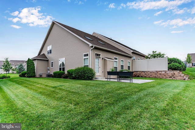 1605 Quincey Dr, Mechanicsburg, PA 17050 - rear view of house featuring a patio area, a lawn, and a shingled roof