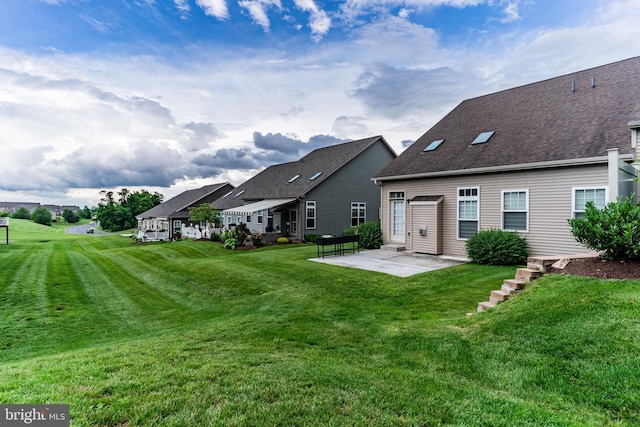 1605 Quincey Dr, Mechanicsburg, PA 17050 - rear view of property with a patio area, a lawn, and roof with shingles