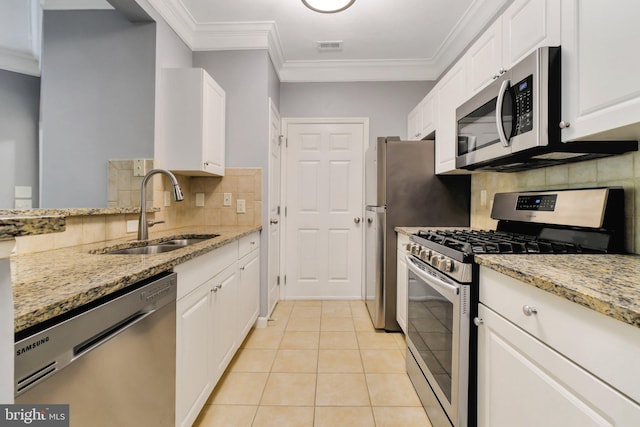 503 Sunset View Ter SE Unit 102, Leesburg, VA 20175 - kitchen featuring stainless steel appliances, backsplash, white cabinetry, light stone counters, and ornamental molding