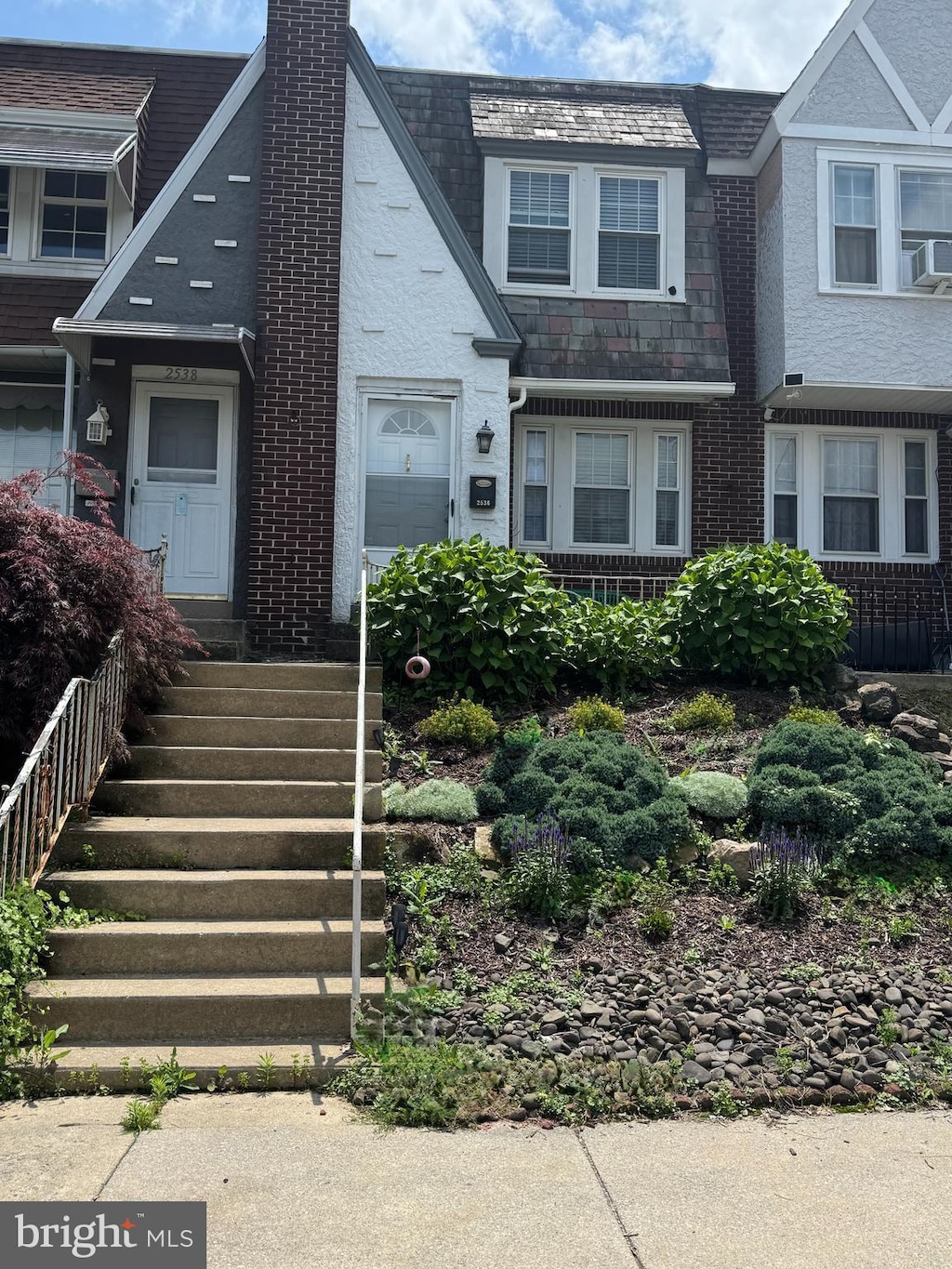 2536 Grant St, Reading, PA 19606 - view of front of home featuring a chimney, a high end roof, brick siding, and cooling unit
