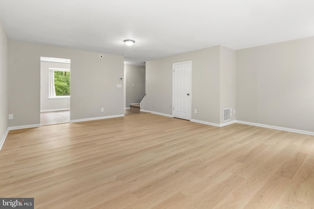 14 Ensign Ct, Essex, MD 21221 - empty room featuring light wood finished floors and stairway