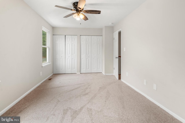 14 Ensign Ct, Essex, MD 21221 - unfurnished bedroom with multiple closets, carpet floors, and a ceiling fan