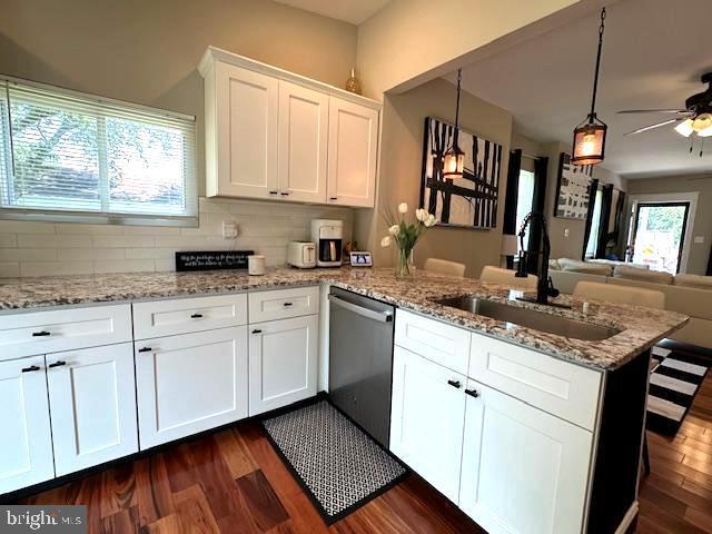 220 Rancocas Rd, Mount Holly, NJ 08060 - kitchen with stainless steel dishwasher, a peninsula, a ceiling fan, white cabinetry, and dark wood finished floors