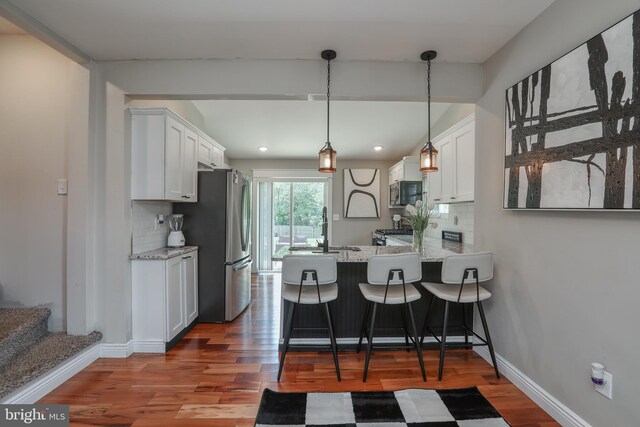 220 Rancocas Rd, Mount Holly, NJ 08060 - kitchen featuring appliances with stainless steel finishes, white cabinets, tasteful backsplash, wood finished floors, and recessed lighting