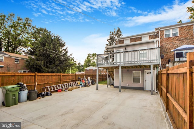 659 Charraway Rd, Baltimore, MD 21229 - rear view of property featuring a deck, a fenced backyard, and a patio