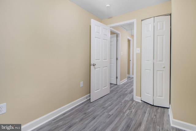 659 Charraway Rd, Baltimore, MD 21229 - unfurnished bedroom with wood finished floors and a closet