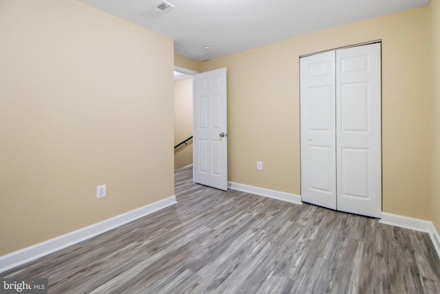 659 Charraway Rd, Baltimore, MD 21229 - unfurnished bedroom featuring wood finished floors and a closet