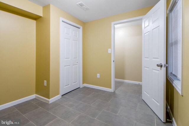 659 Charraway Rd, Baltimore, MD 21229 - unfurnished bedroom featuring baseboards and dark tile patterned floors