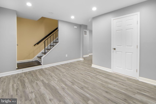 659 Charraway Rd, Baltimore, MD 21229 - unfurnished living room featuring wood finished floors, recessed lighting, and stairs