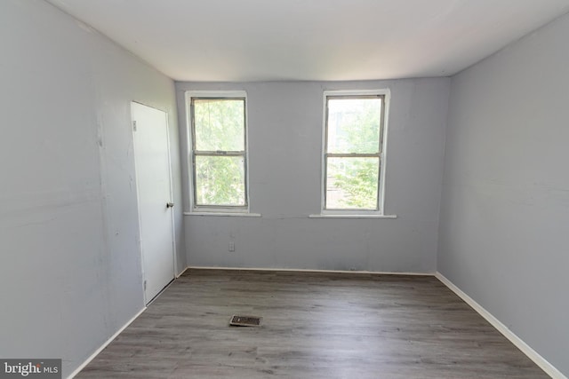 1826 E 28th St, Baltimore, MD 21218 - spare room featuring healthy amount of natural light and wood finished floors