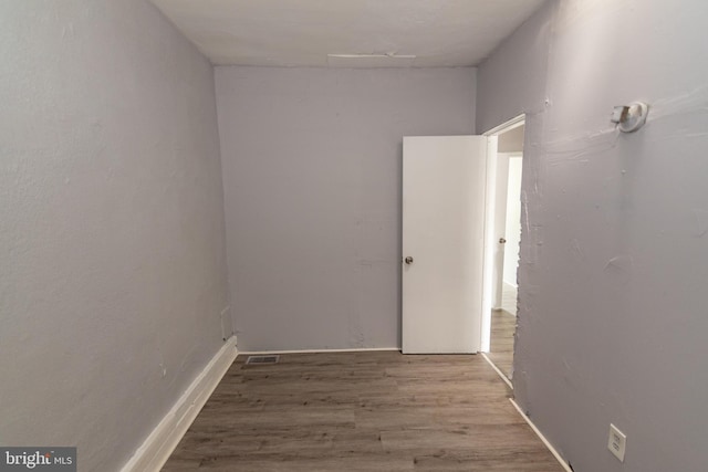 1826 E 28th St, Baltimore, MD 21218 - empty room featuring wood finished floors and baseboards