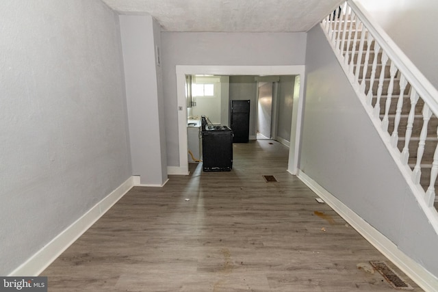 1826 E 28th St, Baltimore, MD 21218 - hallway with stairs, wood finished floors, and washer / clothes dryer