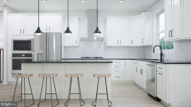 42127 Picasso Sq, Ashburn, VA 20148 - kitchen with stainless steel appliances, dark countertops, a breakfast bar area, white cabinetry, and recessed lighting