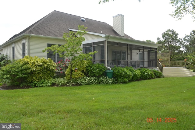 8698 Cummings Rd, Wittman, MD 21676 - rear view of property with a sunroom, a chimney, a lawn, roof with shingles, and a wooden deck