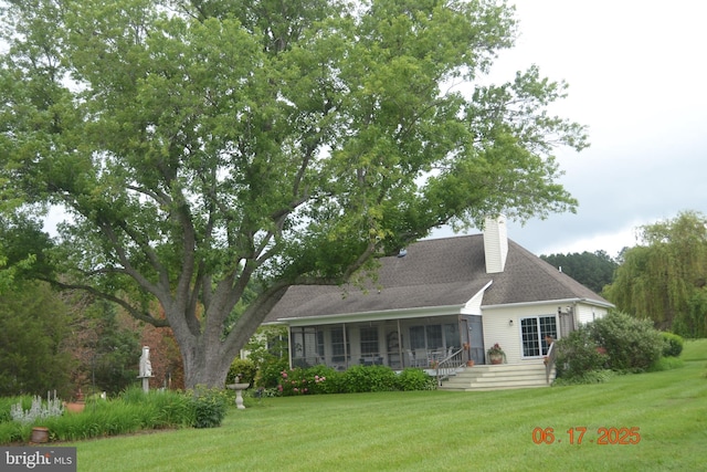 8698 Cummings Rd, Wittman, MD 21676 - back of house featuring a sunroom, a yard, and a chimney