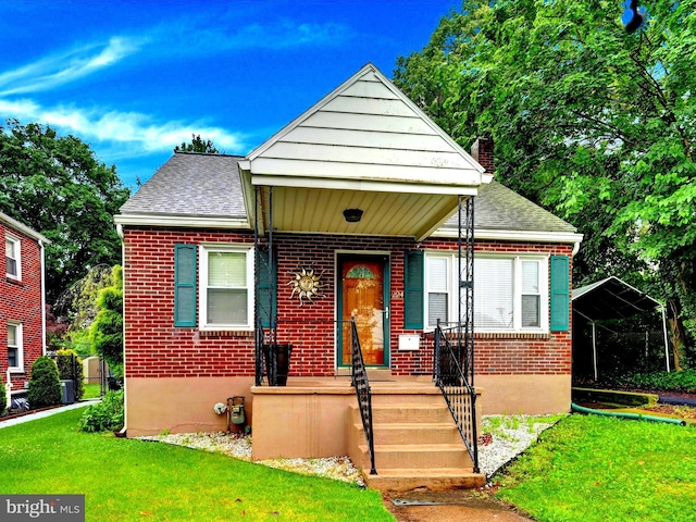 224 Mayberry Ave, Reading, PA 19605 - view of front of house featuring brick siding, a front yard, a chimney, and a shingled roof