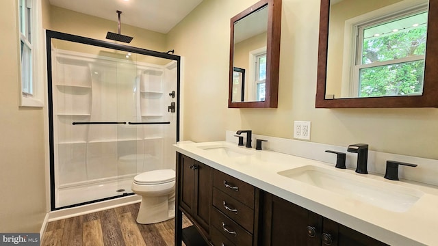 1440 N 26th St, Allentown, PA 18104 - bathroom featuring a stall shower, wood finished floors, and double vanity