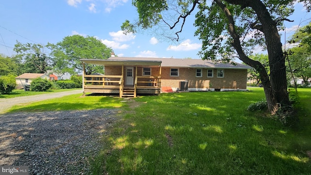1440 N 26th St, Allentown, PA 18104 - rear view of house with brick siding, a yard, a wooden deck, and driveway