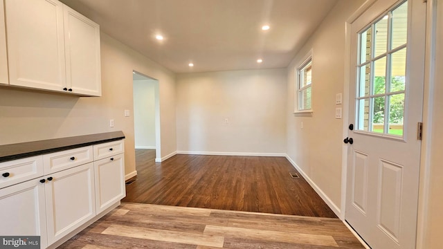 1440 N 26th St, Allentown, PA 18104 - kitchen with wood finished floors, dark countertops, recessed lighting, and white cabinetry