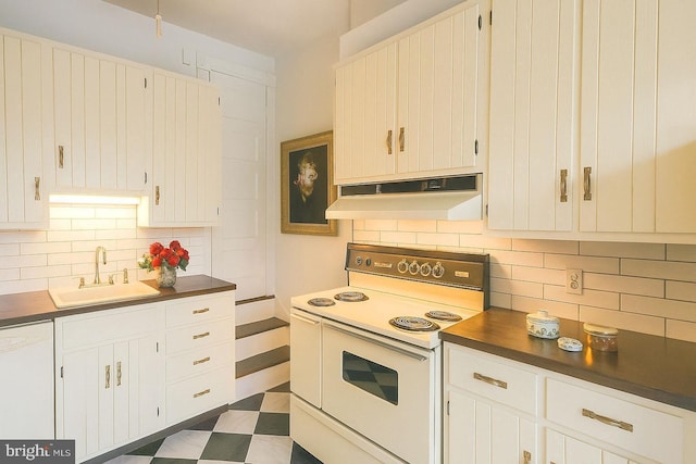 2741 N Calvert St, Baltimore, MD 21218 - kitchen featuring white appliances, under cabinet range hood, dark countertops, and backsplash