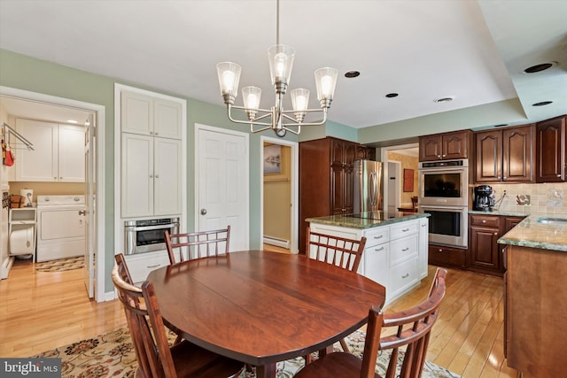 207 Saddle Dr, Furlong, PA 18925 - dining area featuring light wood-style flooring, a chandelier, baseboard heating, washing machine and clothes dryer, and recessed lighting
