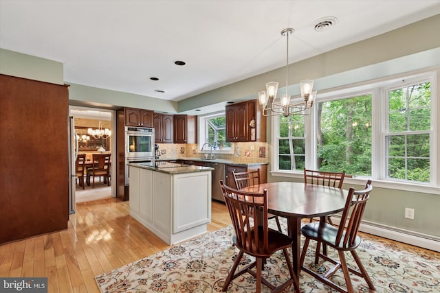 207 Saddle Dr, Furlong, PA 18925 - dining space featuring a chandelier, light wood-style floors, and baseboard heating