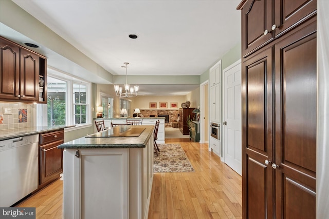 207 Saddle Dr, Furlong, PA 18925 - kitchen featuring dishwasher, black electric stovetop, open floor plan, light wood-style flooring, and a center island