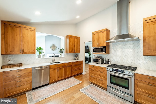 7913 Double Creek Ct, Springfield, VA 22153 - kitchen featuring appliances with stainless steel finishes, wall chimney range hood, lofted ceiling, tasteful backsplash, and light wood-type flooring